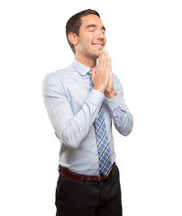 Hopeful young businessman praying