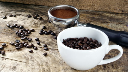 Dark roasting coffee beans. on the wood table.