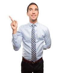 Surprised young businessman pointing up