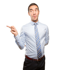 Happy young businessman pointing