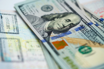 Fototapeta premium American money is on the top of the opened passport