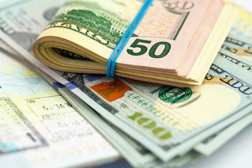 American money is on the top of the opened passport