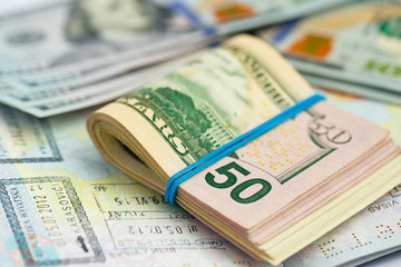 American money is on the top of the opened passport