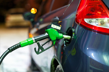 Car refueling on a petrol station in winter at night