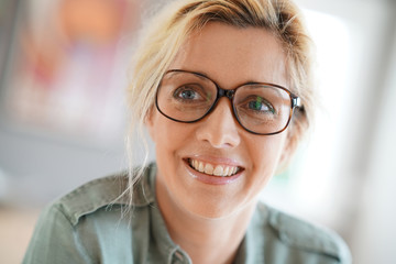 Portrait of blond woman with eyeglasses on