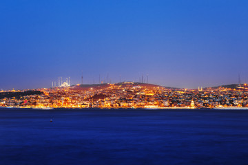 Naklejka premium Istanbul classical night skyline scenery, view over Bosporus channel. Blue sky and blue water of Bosporus channel.