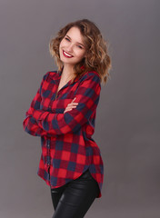Young woman standing, isolated on gray background