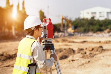 Surveyor engineer is measuring level on construction site. Surveyors ensure precise measurements...