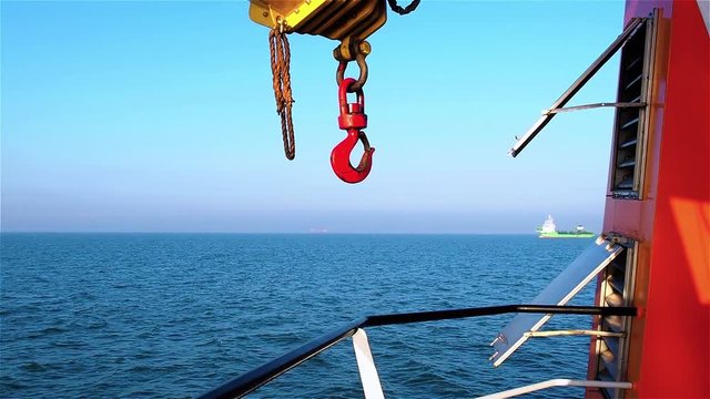 View of dredger vessel from tugs deck on clear day