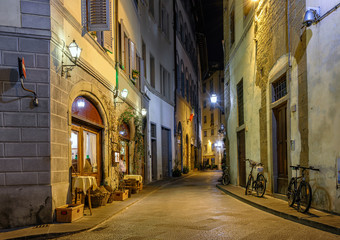 Fototapeta na wymiar Night view of narrow street in Florence, Tuscany. Italy