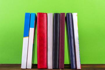 books in a row green background