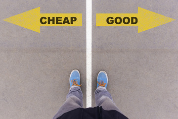 Cheap vs Good text arrows on asphalt ground, feet and shoes on f