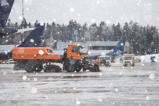 Snowplow cleans snow at the airport during a snowfall