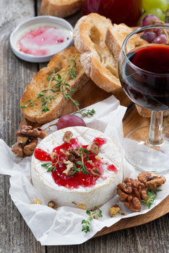 delicious appetizers for wine - camembert, berry jam, toast