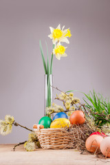 Easter eggs in the basket on a wooden table