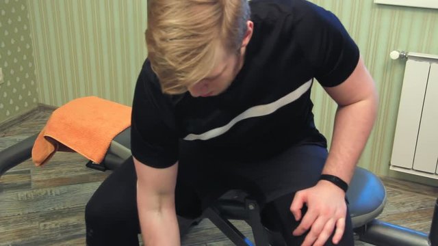 Young man working out his hands lifting dumbels and exercise his biceps