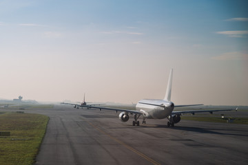 Commercial airplane queue taxiing to take off on runway
