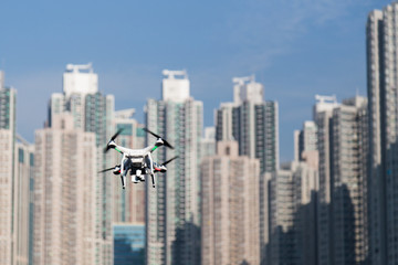 Fototapeta na wymiar Drone doing surveillance take aerial photographs over cityscape