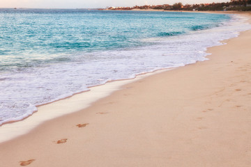 Turquoise Waves Breaking on Sandy Beach in the Bahamas