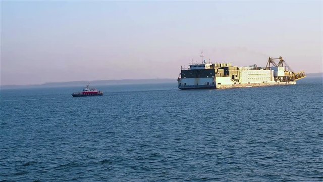 View of boat and pipelayer vessels from tugs deck on clear day