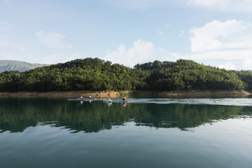 Three young boy at the rowing competition at the lake