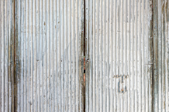Old corrugated metal wall. It is made of galvanized iron sheet.
