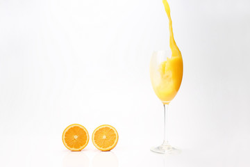 splash of orange juice in the glass on white background