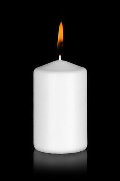 white candle isolated on black