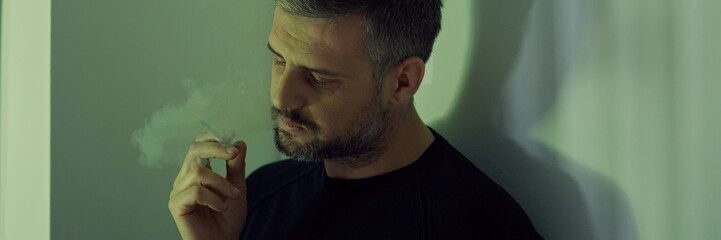 Fototapeta premium Depressed man with cigarette