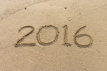 Number of year 2016 on sand. It is writed on beach.
