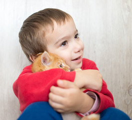Happy little kid holding yellow kitty cat