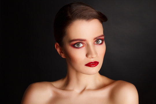 Portrait of beautiful sexy fashion model with red make up over d