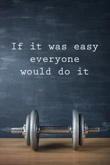 metal barbell on dark gray background and motivation text