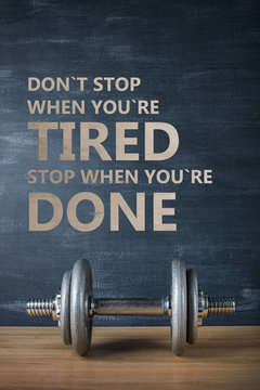 Metal Barbell On Dark Gray Background And Motivation Text