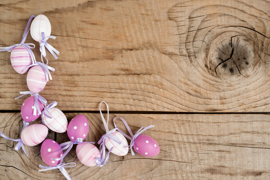 Easter eggs over rustic wooden vintage table - top view, copy space