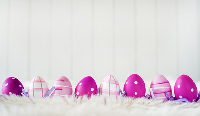 Easter eggs over white striped background - copy space