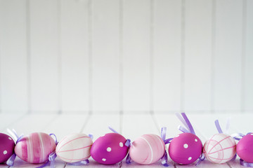 Easter eggs over white striped background - copy space