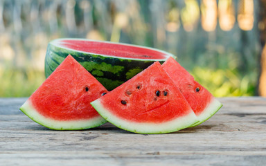 water melon slice on wood texture in nature background.