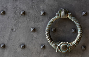 Ancient metal door with handle decorated