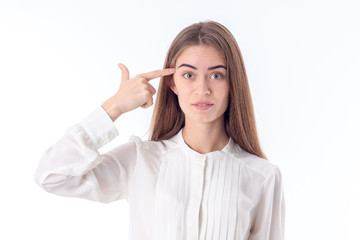 young girl in shirt keeps finger Temple isolated on white background