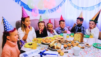 Boys and girls behaving jokingly during friend’s birthday party