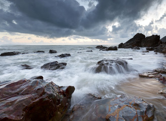 Gloomy morning at the beach with dramatic clouds.