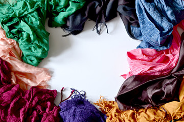 White background framed by multicolored scarfs