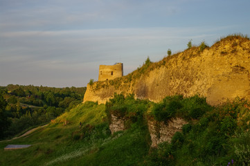 Obraz premium A view of the medieval Izborsk fortress walls and towers in sunset, Pskov region,Russia