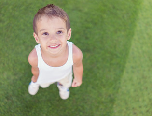 Kid on green grass