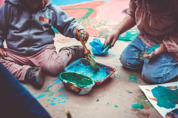 Children playing with tempera paints - 136954969
