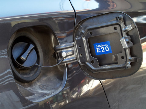 open car fuel cap with gasohol E20 sticker, automotive refueling, alternative fuel usage