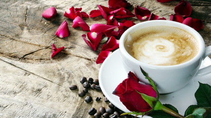 Cappuccino coffee with roses. A cup of latte, cappuccino or espresso coffee with milk put on a wood table with dark roasting coffee beans. Drawing the foam milk on top.
