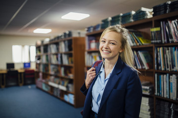 Portrait of a teen student in the library of her school.