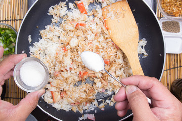 Chef putting sugar for cooking rice